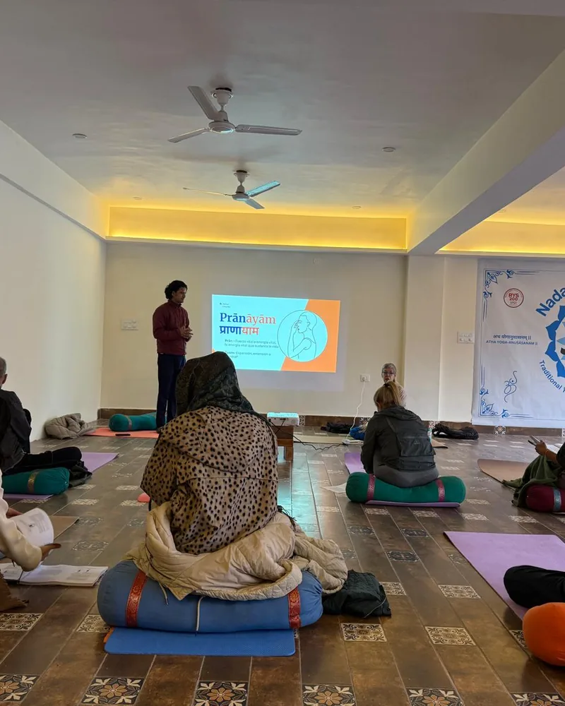Teacher presenting yoga anatomy to students in Rishikesh